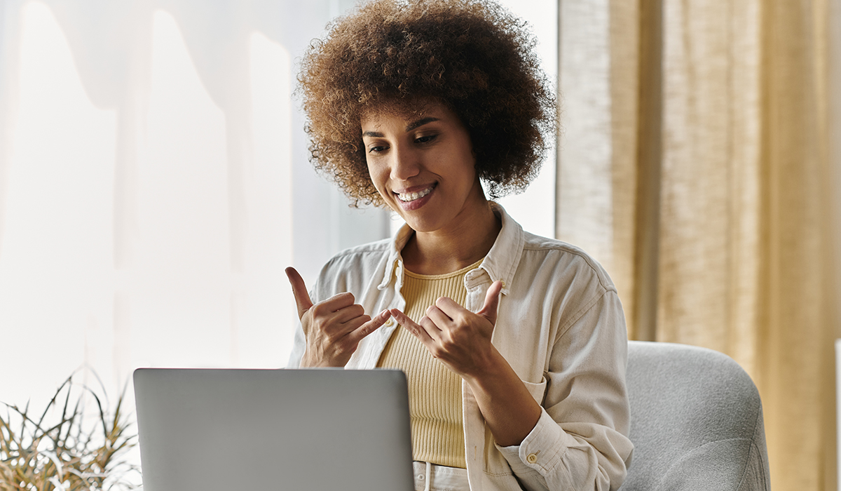 woman holding laptop signing